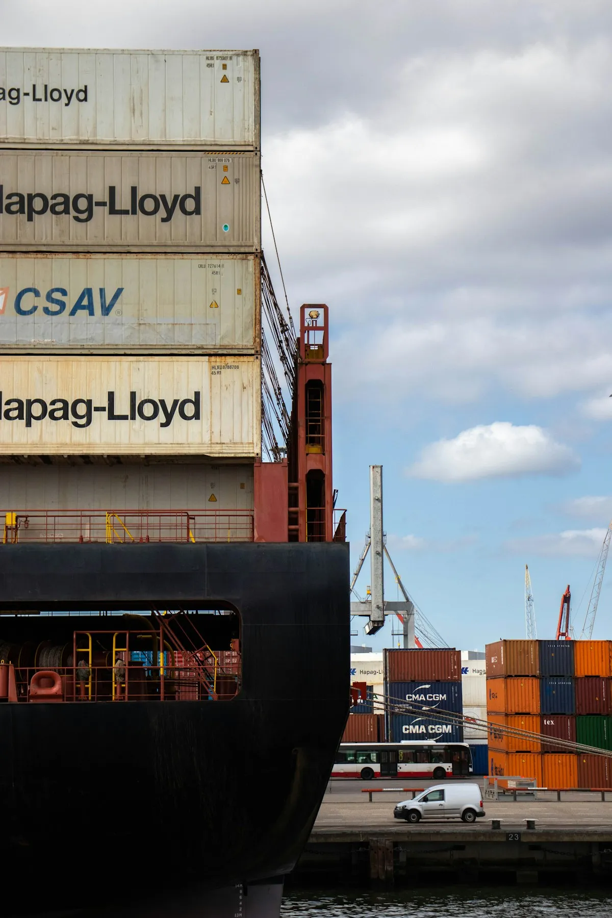 A large cargo ship docked at port, symbolizing the global logistics infrastructure that enables international precious metals storage and transport