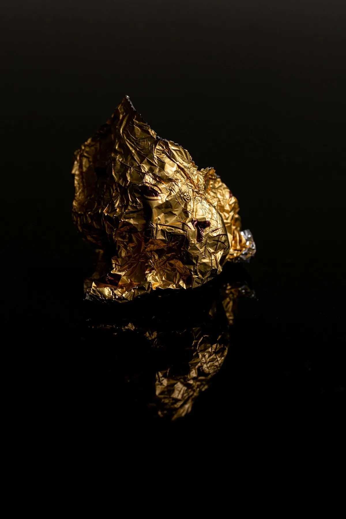 A stone fragment showing the raw mineral material that must undergo extensive processing before yielding refined gold