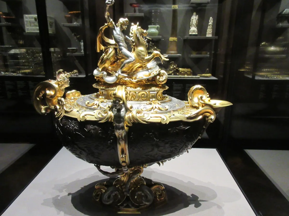 Gold and black ornamental disk representing the ceremonial role of gold in imperial power