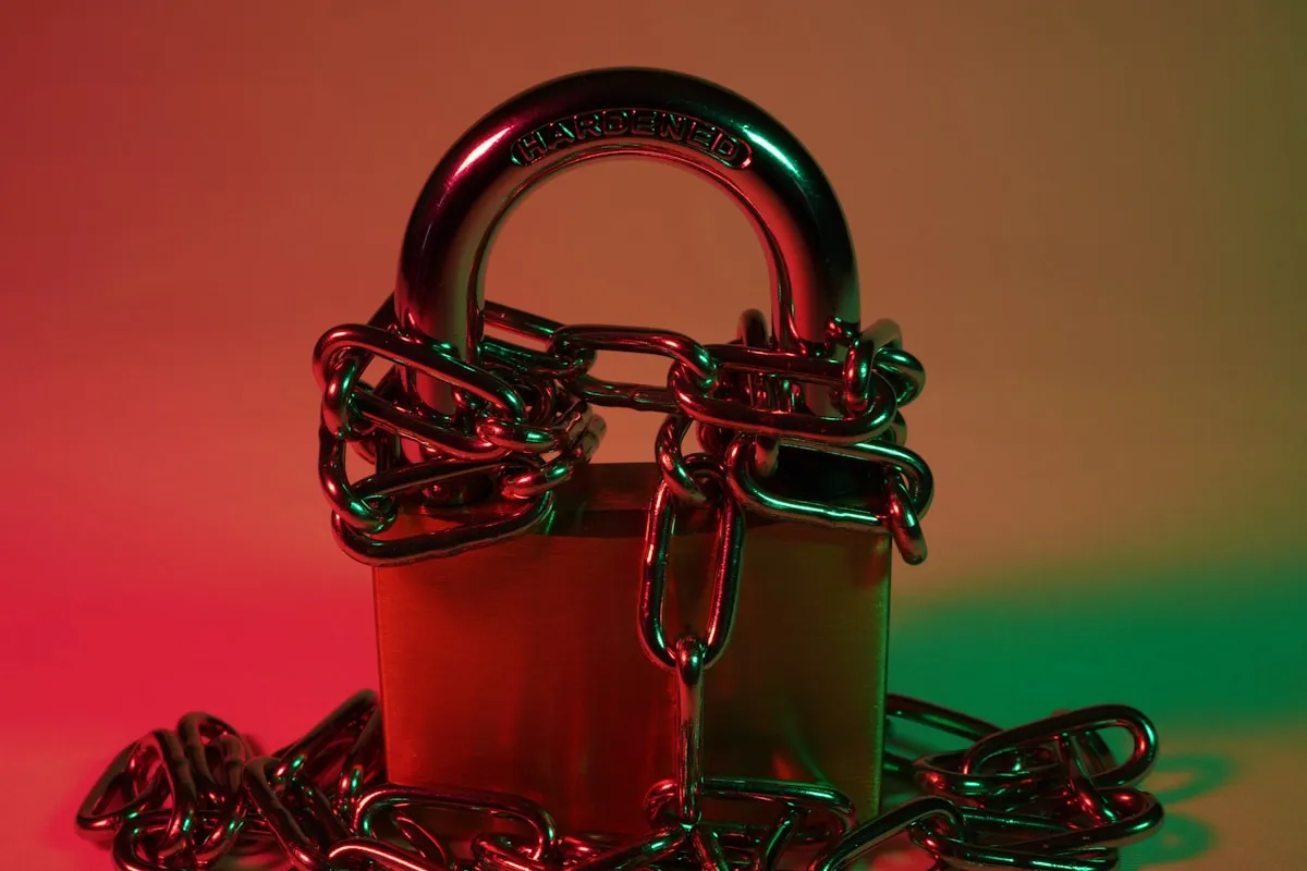 A red padlock secured to a heavy metal chain, symbolizing the security gaps in standard insurance coverage that leave precious metals unprotected