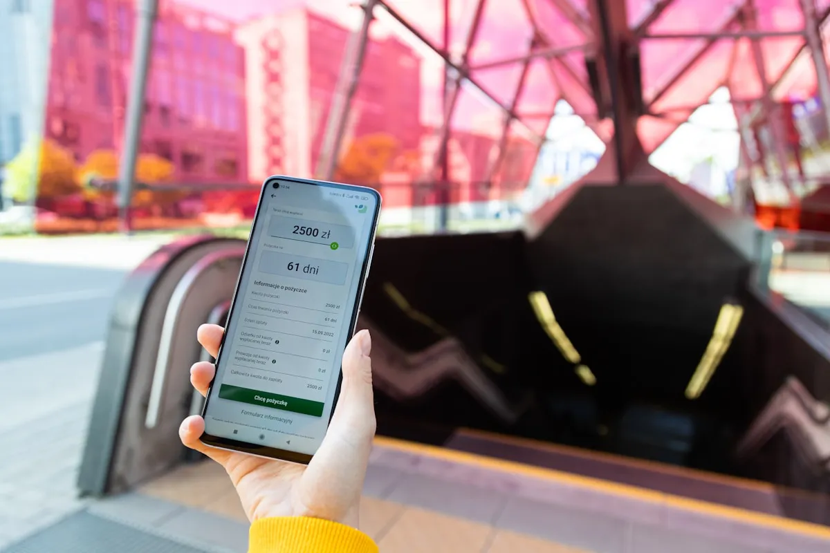 A hand holding a modern smartphone, representing the electronics industry that consumes the majority of industrial gold demand