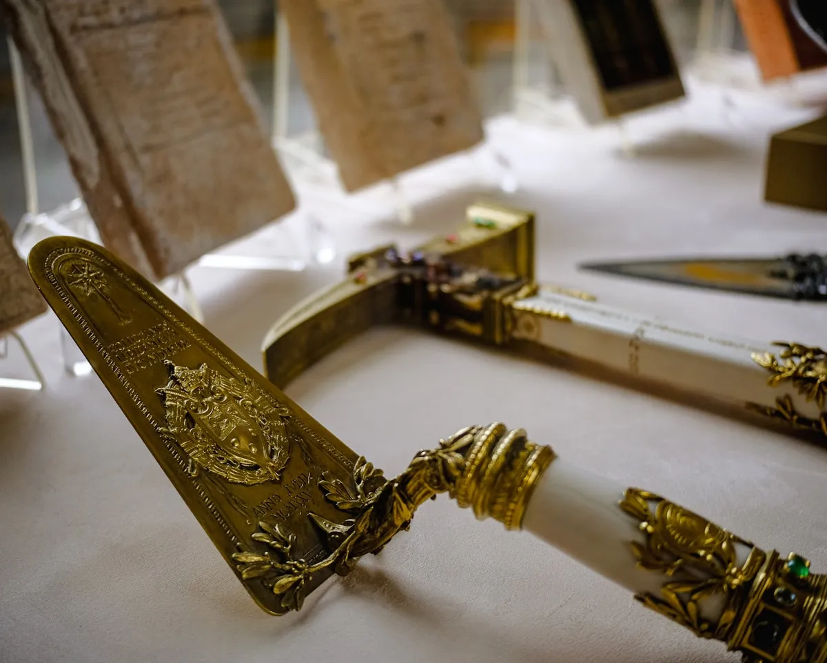 A collection of gold-colored ceremonial objects arranged on a table, reflecting the universal human impulse to craft sacred items from gold