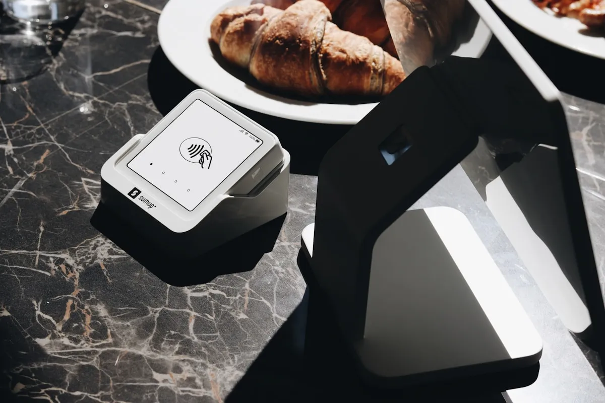 Food and laptop on a table, representing the careful at-home review process when verifying a gold delivery