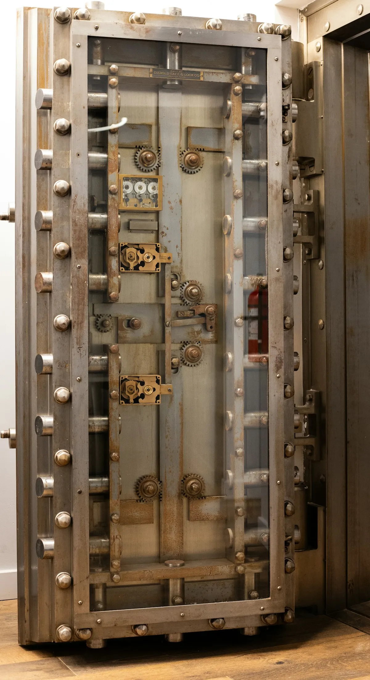 Close-up of metal door knobs on a secure vault door, representing the security infrastructure needed for gold storage