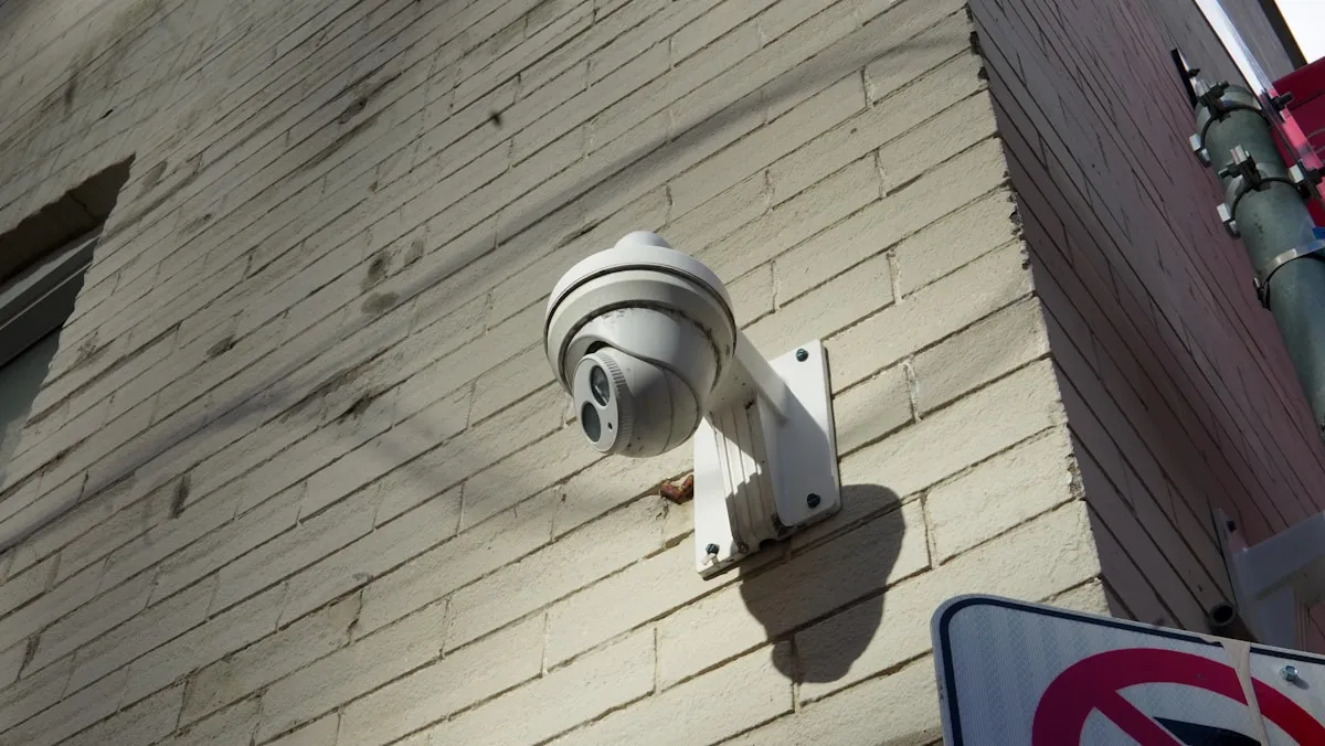A security camera mounted on a brick wall, representing the surveillance systems that form a critical layer of precious metals defense