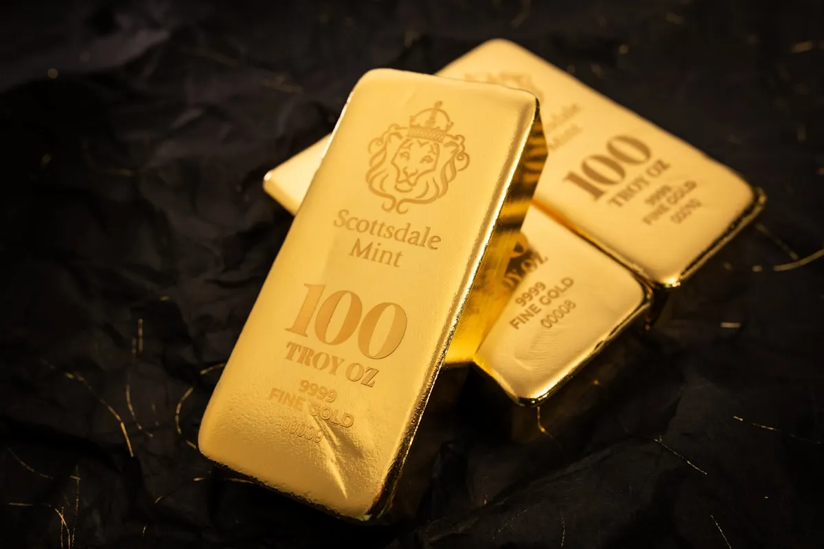 Gold bars arranged on a dark surface representing physical gold held within an IRA
