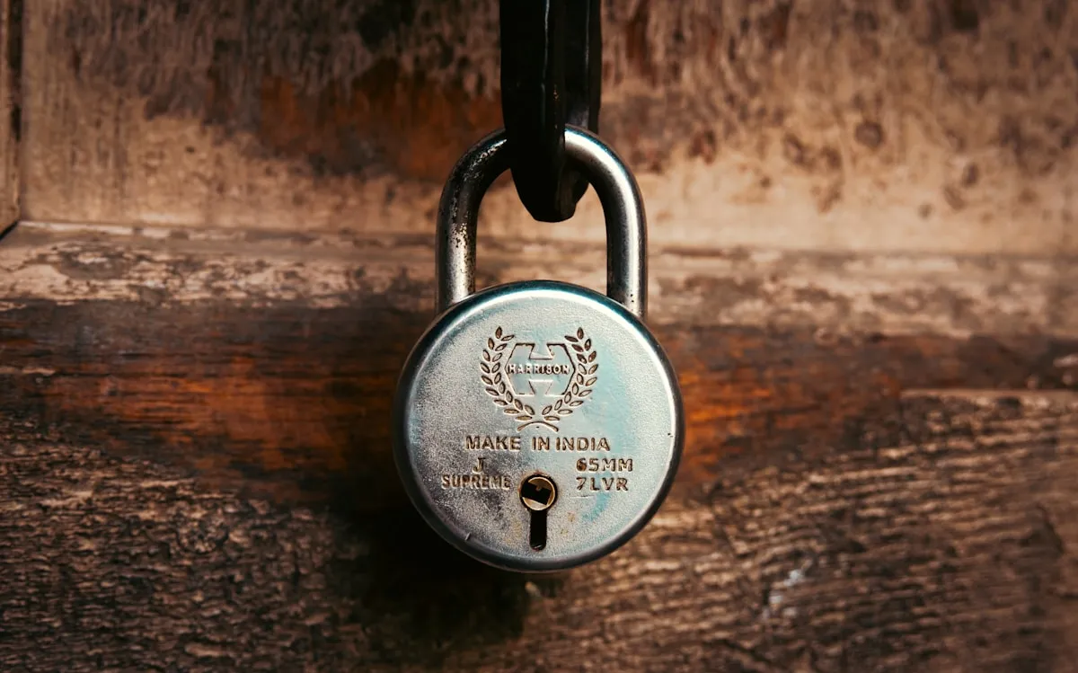An old padlock securing a weathered wooden door, a reminder that even well-protected storage spaces harbor invisible environmental threats that require constant vigilance